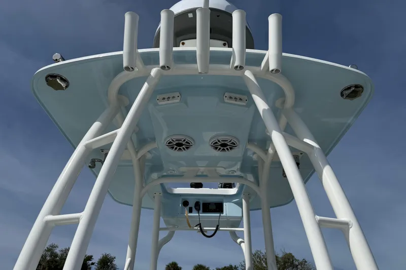Slide: The Image of 2023 Yellowfin 26 Hybrid boat's T-top structure with speakers and rod holders. - 31