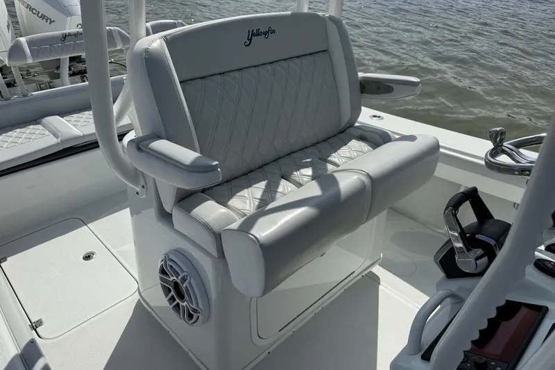 Slide: The Image of 2023 Yellowfin 26 Hybrid boat interior with cushioned seating and steering controls. - 33