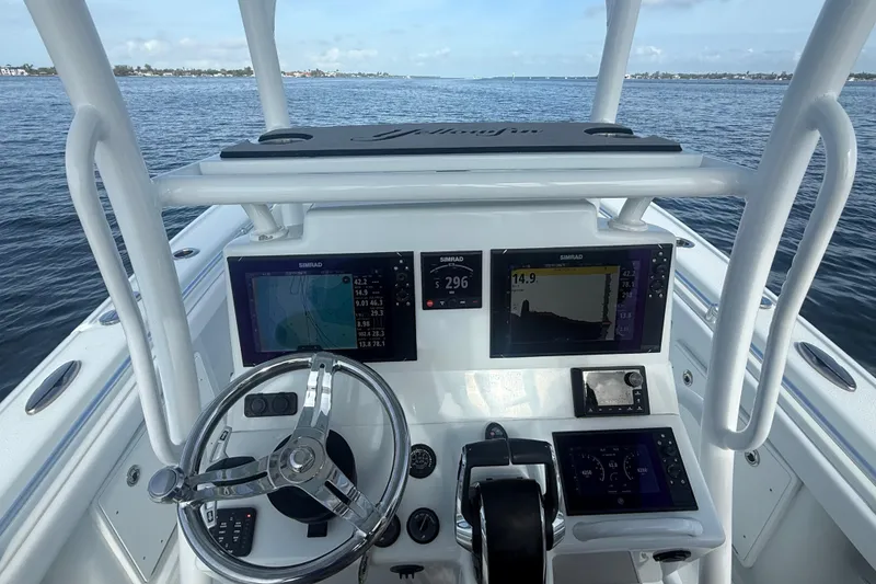 Slide: The Image of 2023 Yellowfin 26 Hybrid boat dashboard with advanced navigation and control systems on open water. - 36