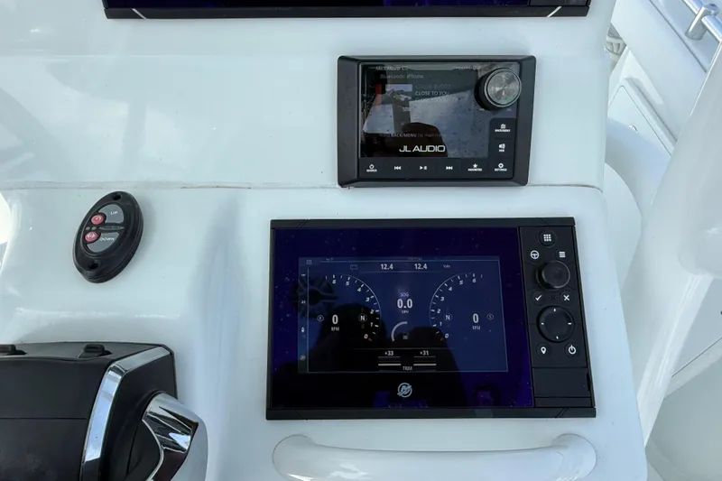 Slide: The Image of 2023 Yellowfin 26 Hybrid boat dashboard with JL Audio system and digital display. - 41