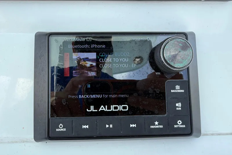 Slide: The Image of JL Audio MediaMaster display on 2023 Yellowfin 26 Hybrid boat, playing music via Bluetooth. - 42