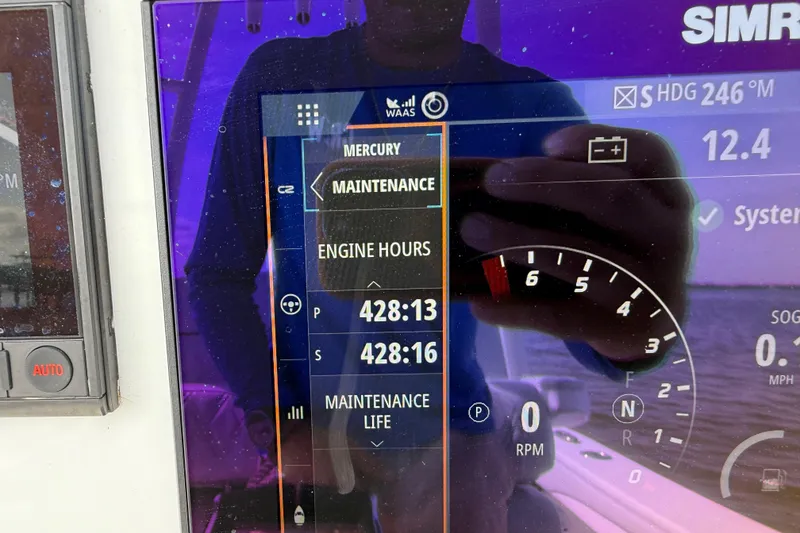 Slide: The Image of Dashboard of 2023 Yellowfin 26 Hybrid showing engine hours and maintenance details. - 43
