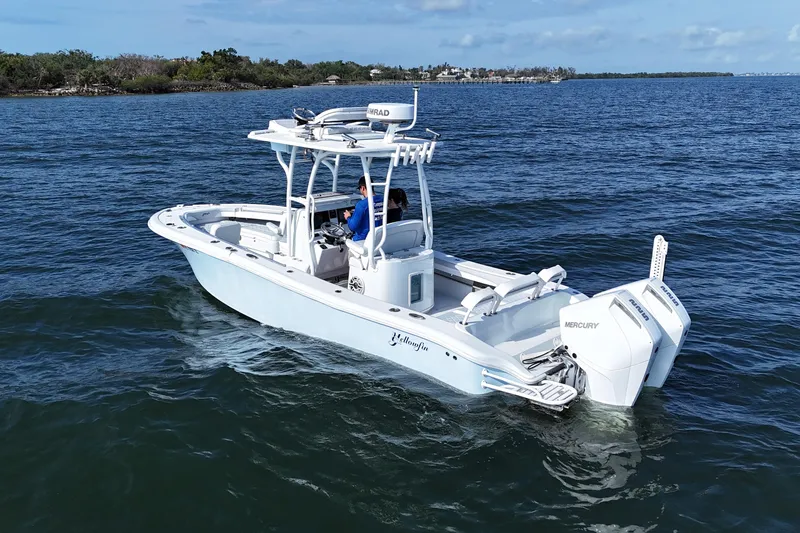 Slide: The Image of 2023 Yellowfin 26 Hybrid boat cruising on open water, featuring dual Mercury engines. - 5