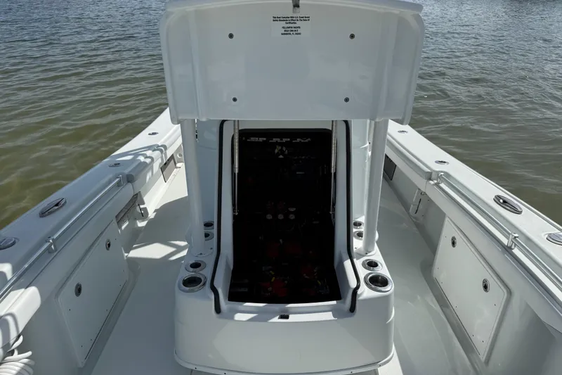 Slide: The Image of 2023 Yellowfin 26 Hybrid boat interior with open hatch, showcasing storage and seating. - 52