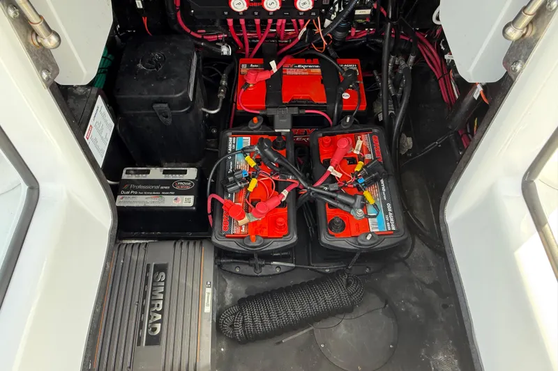Slide: The Image of Battery compartment of 2023 Yellowfin 26 Hybrid boat with wiring and equipment. - 54