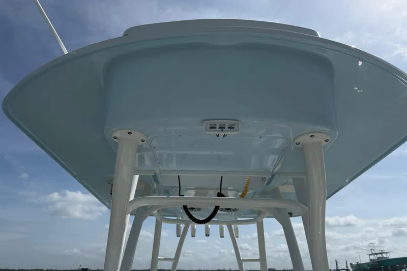 Slide: The Image of 2023 Yellowfin 26 Hybrid boat's underside view with clear sky background. - 57