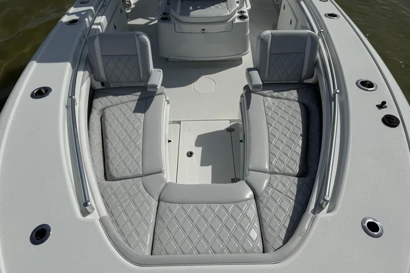 Slide: The Image of 2023 Yellowfin 26 Hybrid boat with luxurious gray seating and diamond stitching. - 58