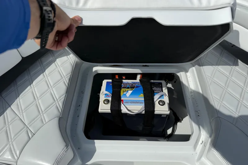 Slide: The Image of 2023 Yellowfin 26 Hybrid boat battery compartment with secured battery. - 61