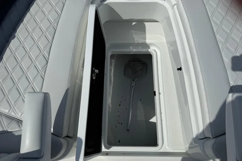 Slide: The Image of 2023 Yellowfin 26 Hybrid boat storage compartment with diamond-stitched seating. - 65