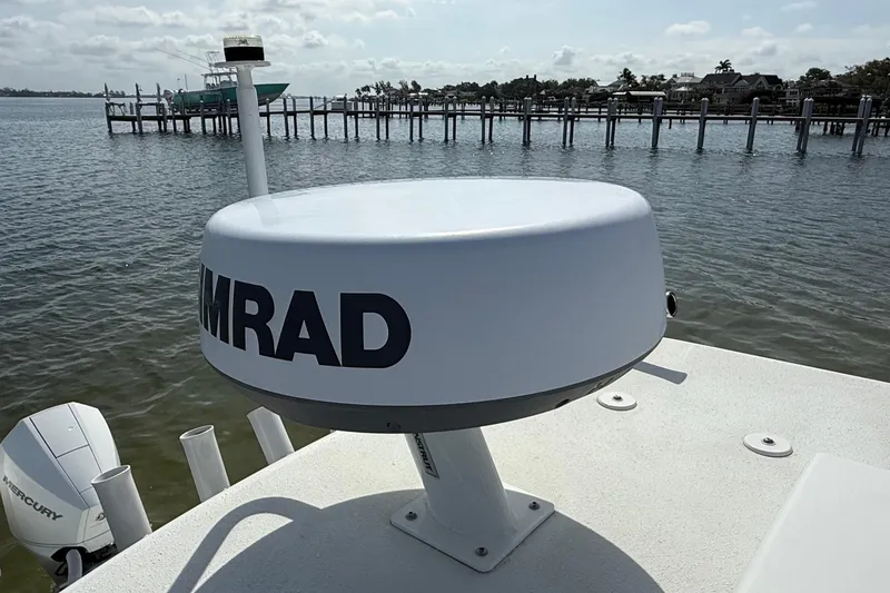 Slide: The Image of Radar system on 2023 Yellowfin 26 Hybrid boat, docked by a scenic waterfront. - 67