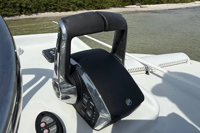 Slide: The Image of Throttle control on 2023 Yellowfin 26 Hybrid boat, near shoreline. - 71
