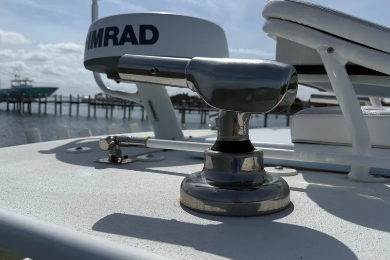 Slide: The Image of 2023 Yellowfin 26 Hybrid boat deck with Simrad equipment, docked by the water. - 74