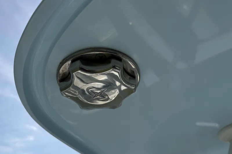 Slide: The Image of Close-up of a 2023 Yellowfin 26 Hybrid boat's metallic fitting against a blue sky. - 75