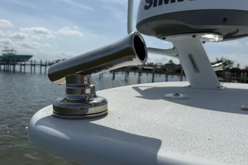 Slide: The Image of 2023 Yellowfin 26 Hybrid boat detail with stainless steel fitting, docked by the water. - 76