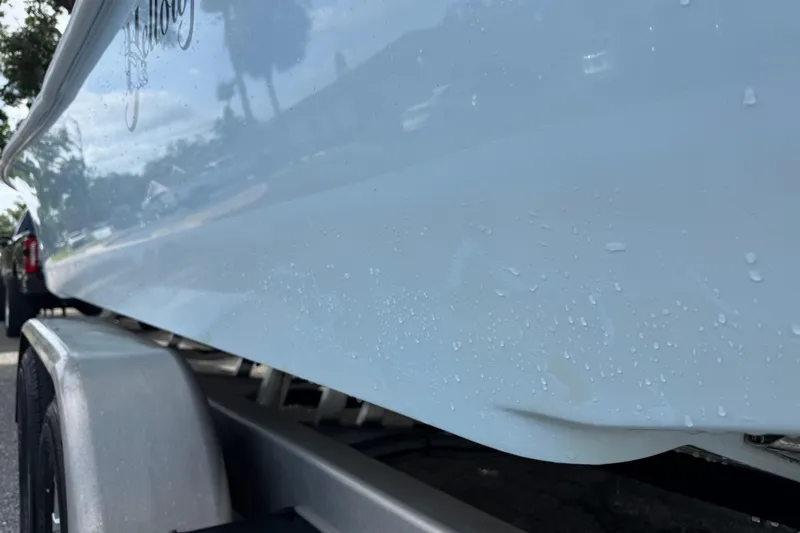 Slide: The Image of 2023 Yellowfin 26 Hybrid boat on trailer, close-up view with water droplets. - 78