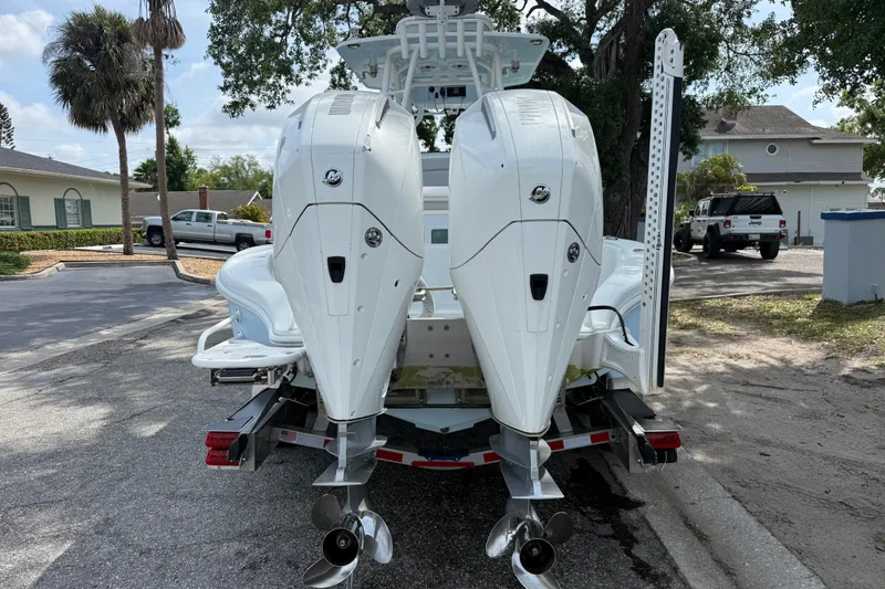 Slide: The Image of 2023 Yellowfin 26 Hybrid boat with dual outboard motors on a trailer. - 80