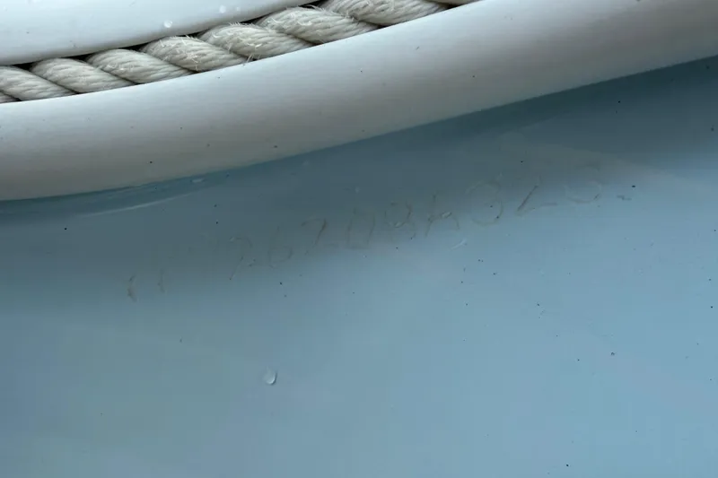 Slide: The Image of Close-up of a 2023 Yellowfin 26 Hybrid boat hull with rope detail. - 83