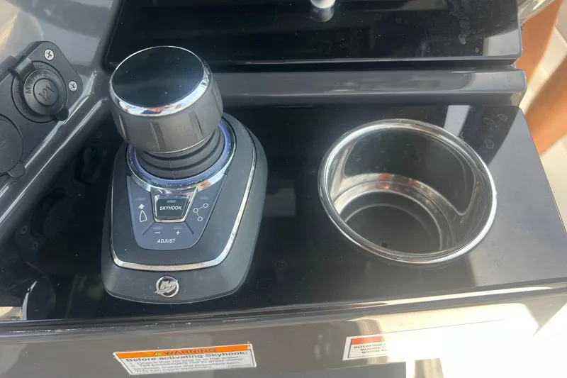 Slide: The Image of Joystick control and cup holder on 2023 Blackfin 302 CC boat dashboard. - 13