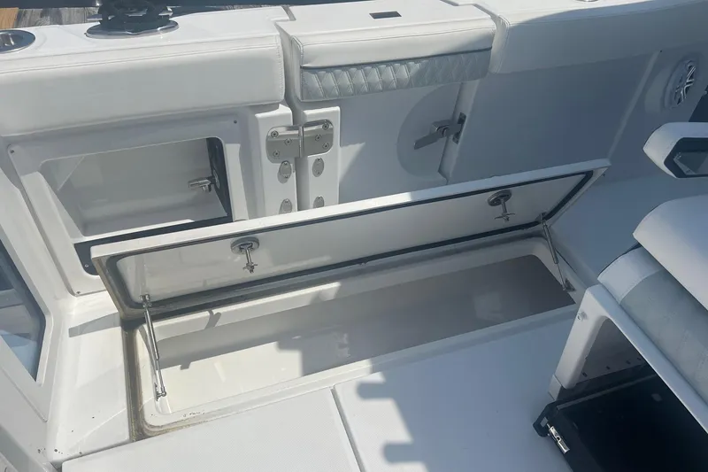 Slide: The Image of 2023 Blackfin 302 CC boat storage compartment with open hatch, showcasing sleek design. - 14