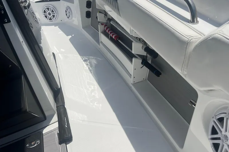 Slide: The Image of 2023 Blackfin 302 CC boat interior with rod holders and speakers. - 19
