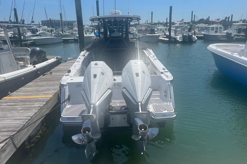 Slide: The Image of 2023 Blackfin 302 CC boat docked at marina with twin engines. - 22