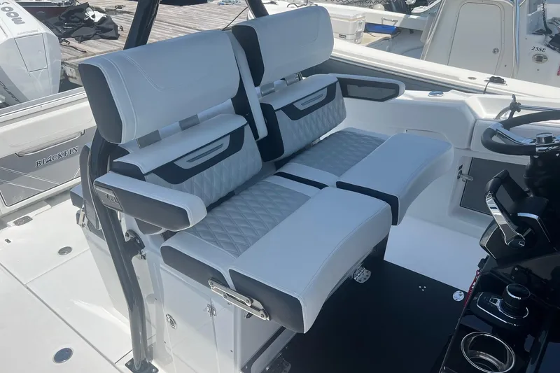 Slide: The Image of 2023 Blackfin 302 CC boat interior with luxurious seating and modern controls. - 8