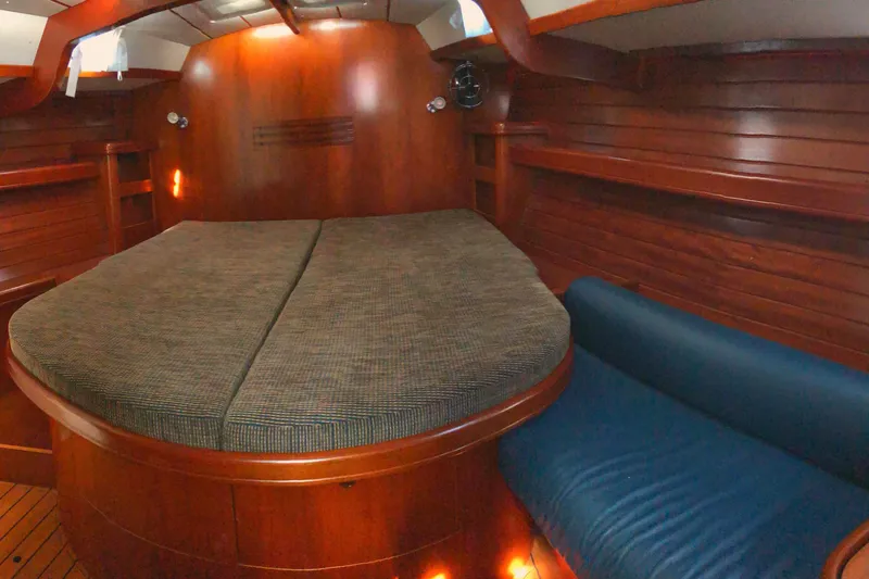 Slide: The Image of Luxurious wooden interior of 2001 Beneteau 50 yacht cabin with cozy bed and seating. - 10