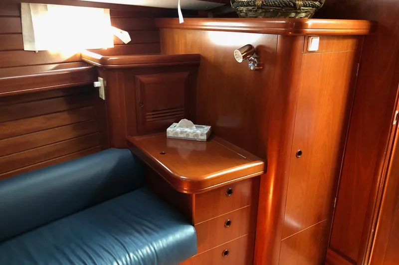 Slide: The Image of Interior of 2001 Beneteau 50 yacht with wooden cabinetry and blue seating. - 11