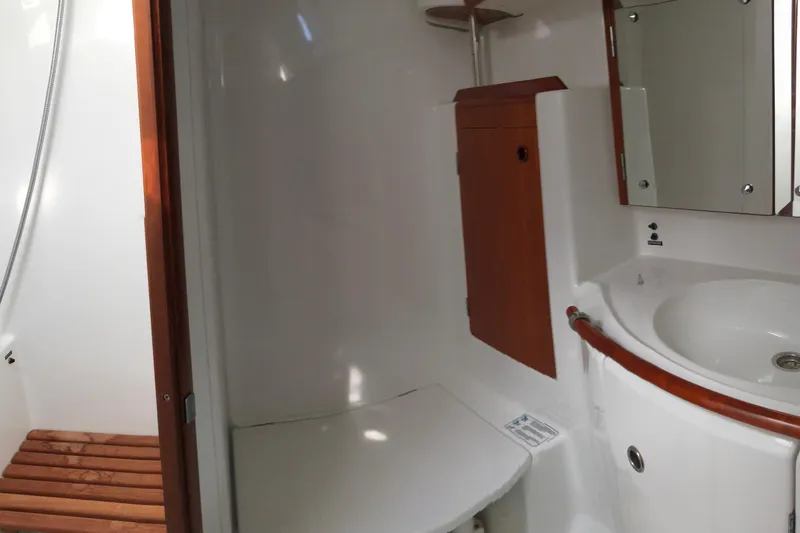 Slide: The Image of Bathroom interior of a 2001 Beneteau 50 yacht, featuring a sink and wooden accents. - 12