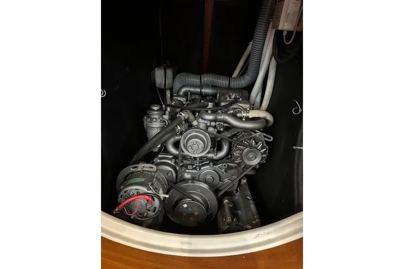 Slide: The Image of Engine compartment of a 2001 Beneteau 50 sailboat, showcasing mechanical components. - 14