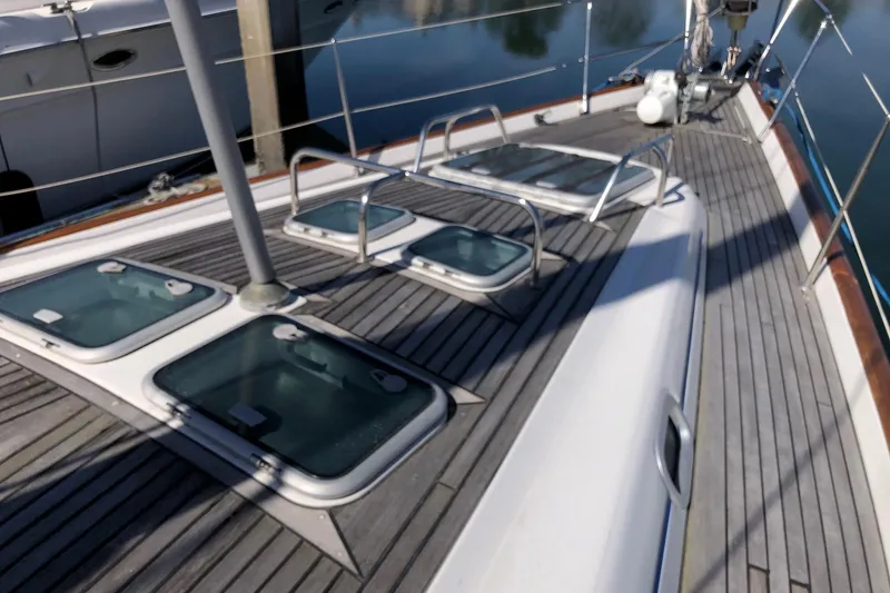 Slide: The Image of Deck of 2001 Beneteau 50 sailboat with hatches and railings. - 16