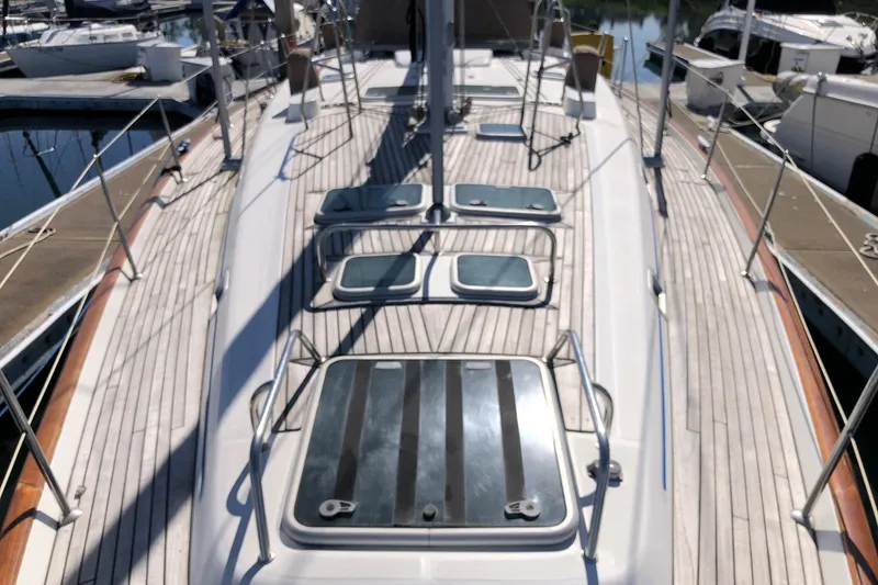 Slide: The Image of Deck view of a 2001 Beneteau 50 yacht in a marina setting. - 17