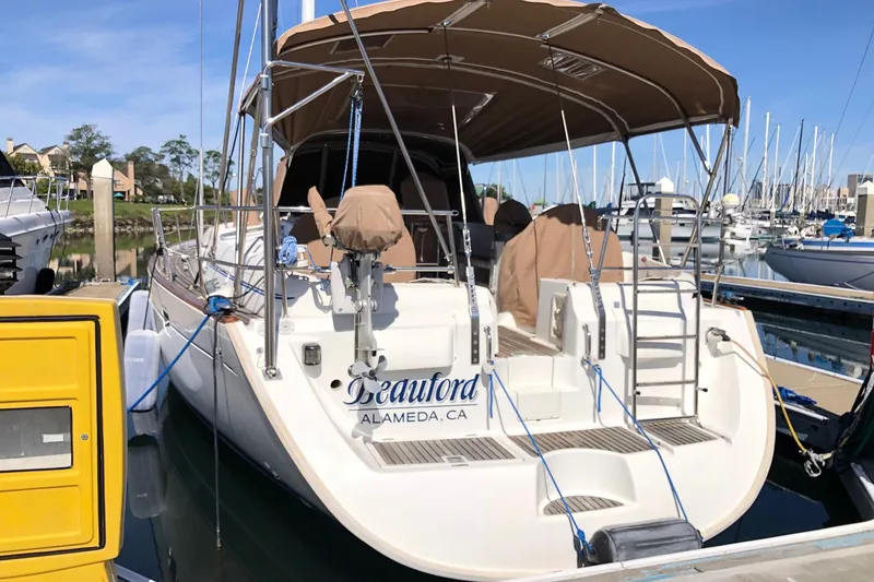 Slide: The Image of Beneteau 50 sailboat, 2001 model, docked in a marina under a sunny sky. - 24