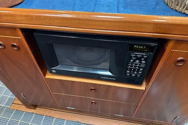 Slide: The Image of Built-in microwave in a 2001 Beneteau 50 yacht's wooden cabinetry. - 3