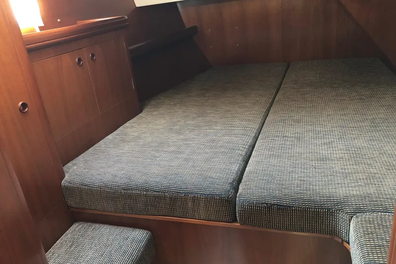 Slide: The Image of Interior cabin of a 2001 Beneteau 50 yacht with cushioned seating. - 6