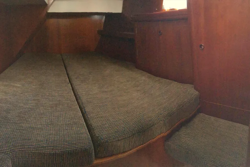 Slide: The Image of Interior cabin of a 2001 Beneteau 50 yacht with cushioned seating. - 8