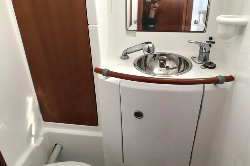 Slide: The Image of Compact bathroom on a 2001 Beneteau 50 yacht with sink and mirror. - 9