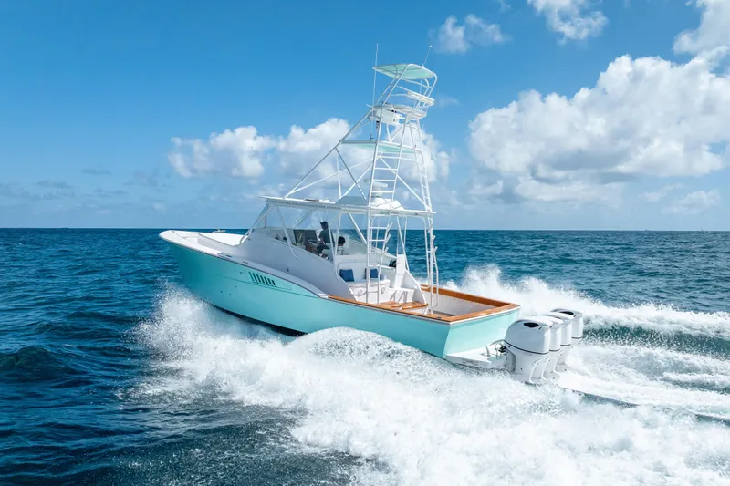 Slide: The Image of 2025 Rybovich Custom Margaritavich boat cruising on open ocean under clear blue sky. - 11