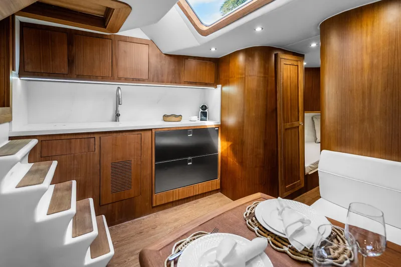 Slide: The Image of Luxurious 2025 Rybovich Custom Margaritavich yacht interior with modern kitchen and dining area. - 19