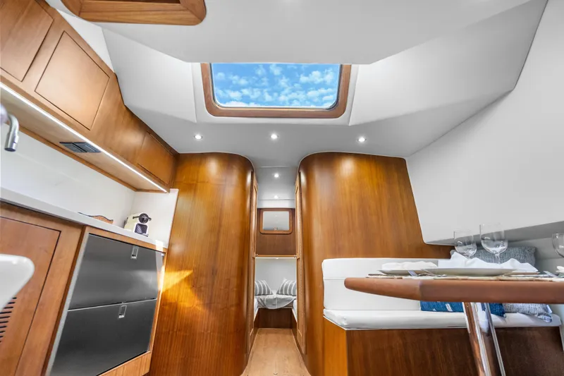 Slide: The Image of Luxurious interior of 2025 Rybovich Custom Margaritavich yacht with skylight and elegant wood finish. - 20