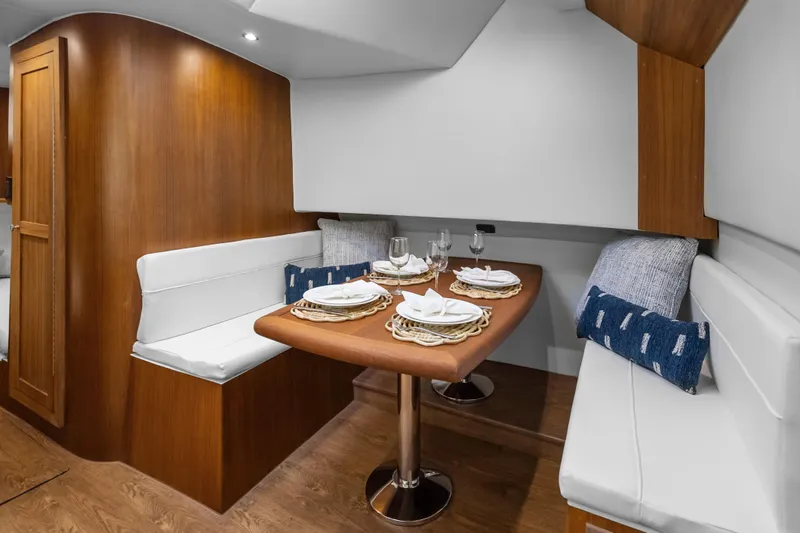 Slide: The Image of Luxurious dining area in 2025 Rybovich Custom Margaritavich yacht with elegant table setting. - 23