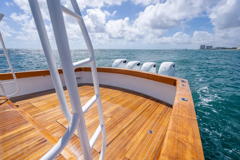 Slide: The Image of Custom Margaritavich 2025 boat with wooden deck, ocean view, and multiple outboard motors. - 42