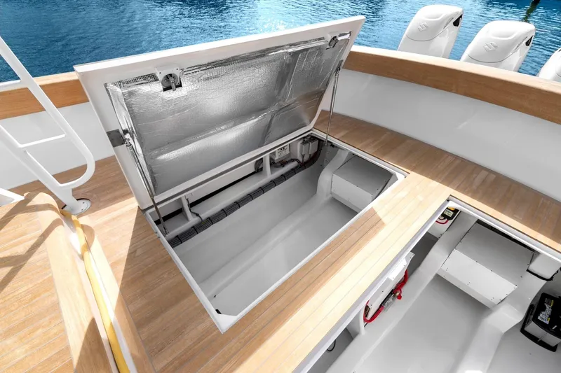 Slide: The Image of Open hatch on 2025 Rybovich Custom Margaritavich boat, revealing storage compartment. - 46