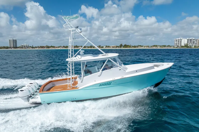 Slide: The Image of 2025 Rybovich Custom Margaritavich yacht cruising on blue ocean waters under a cloudy sky. - 50