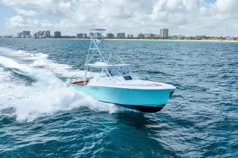 Slide: The Image of 2025 Rybovich Custom Margaritavich boat cruising on ocean near city skyline. - 52