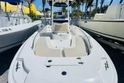 Slide: The Image of 2017 Boston Whaler 240 Outrage boat docked, showcasing spacious deck and seating. - 3