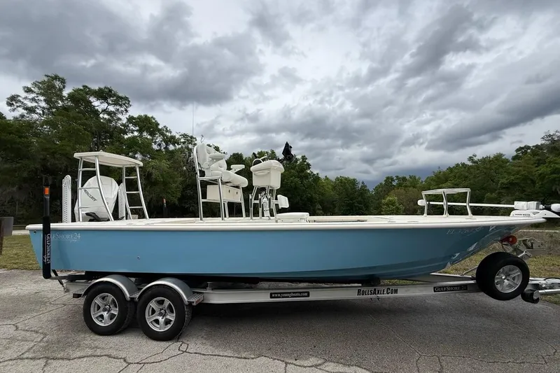 The Image of 2021 Young Boats Gulf Shores 24 on trailer, parked outdoors under cloudy sky. - 0