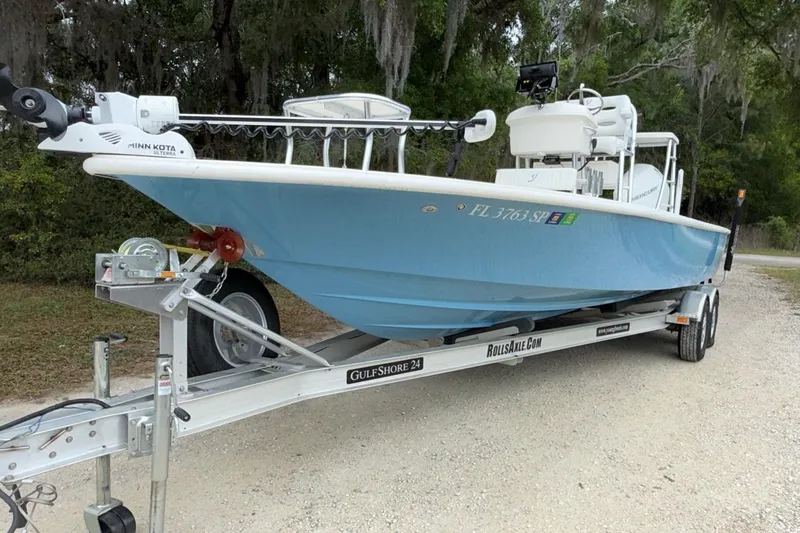 Slide: The Image of 2021 Young Boats Gulf Shores 24 on trailer, featuring Minn Kota trolling motor. - 4