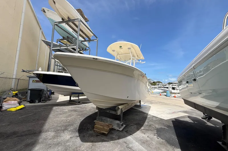 Slide: The Image of 2016 Sea Fox 226 Commander boat in a marina storage area under clear blue skies. - 1
