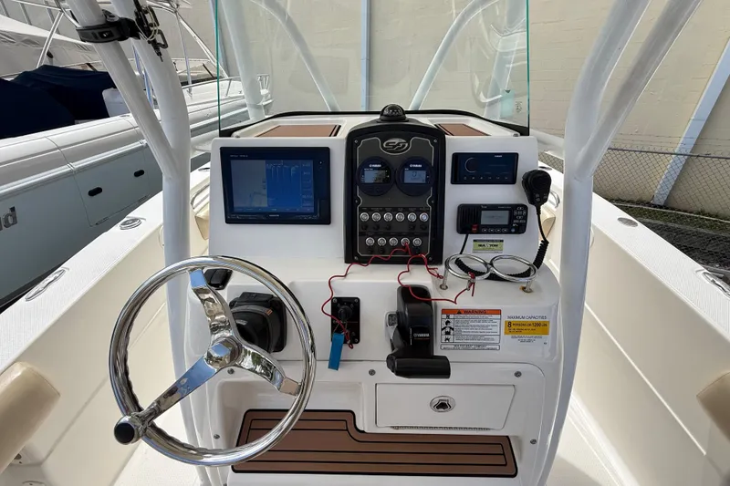 Slide: The Image of 2016 Sea Fox 226 Commander boat dashboard with steering wheel and navigation controls. - 11